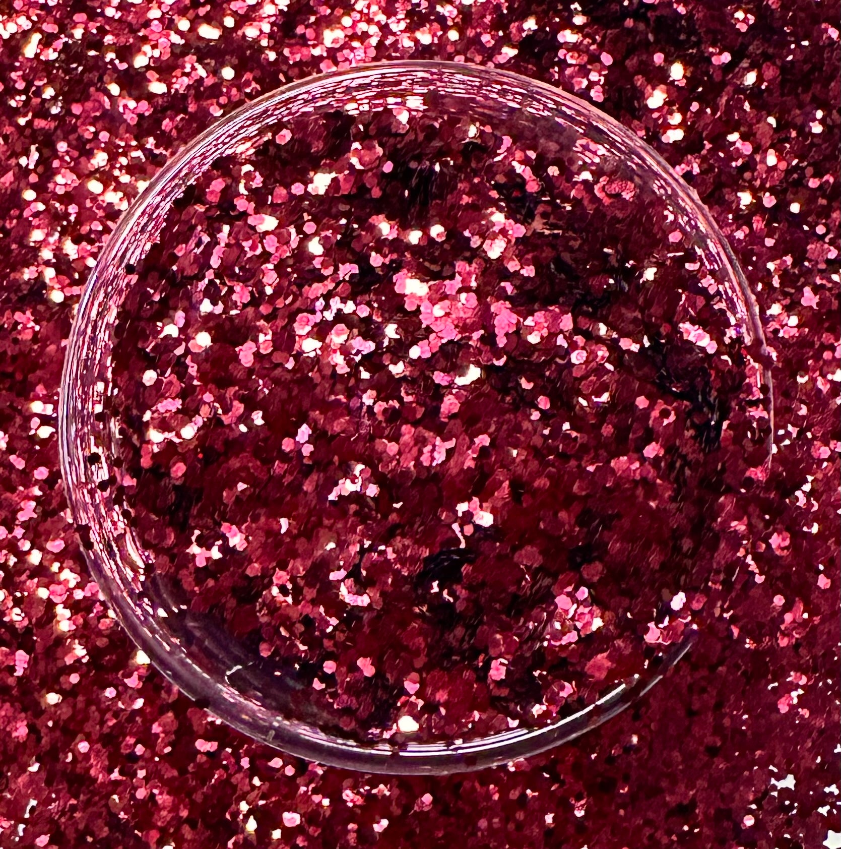 Burgundy medium cut glitter in a glass jar.